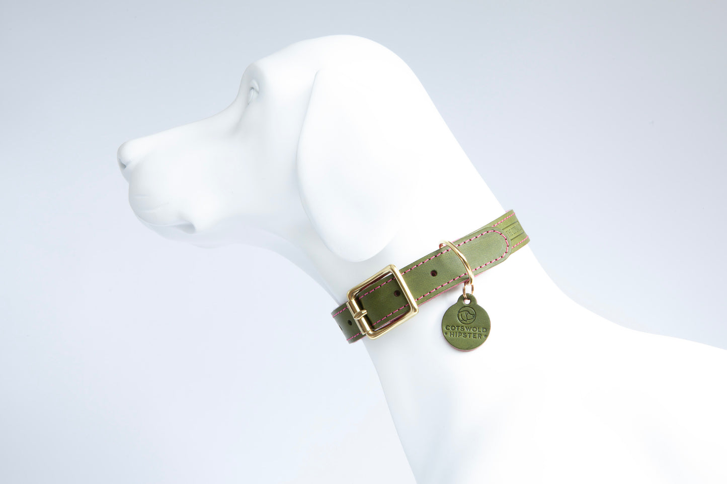 Side view of large dog mannequin wearing Olive & Raspberry handmade leather dog collar with wool felt lining and solid brass buckle, made by Cotswold Hipster
