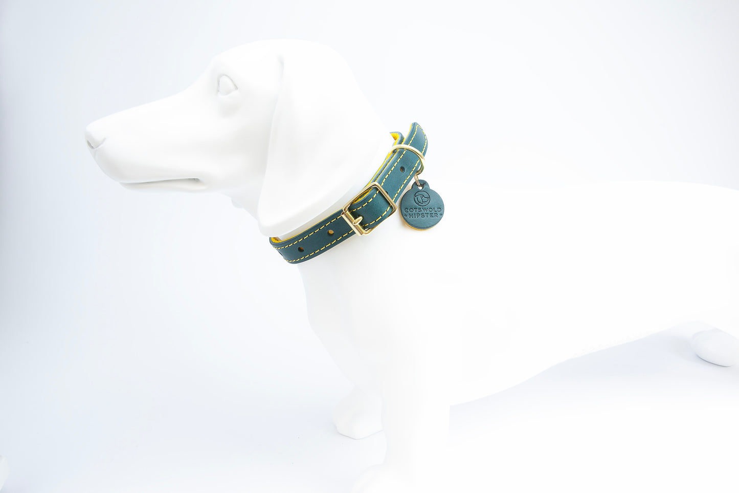 Teal and mustard leather dog collar on a small dog manniquin