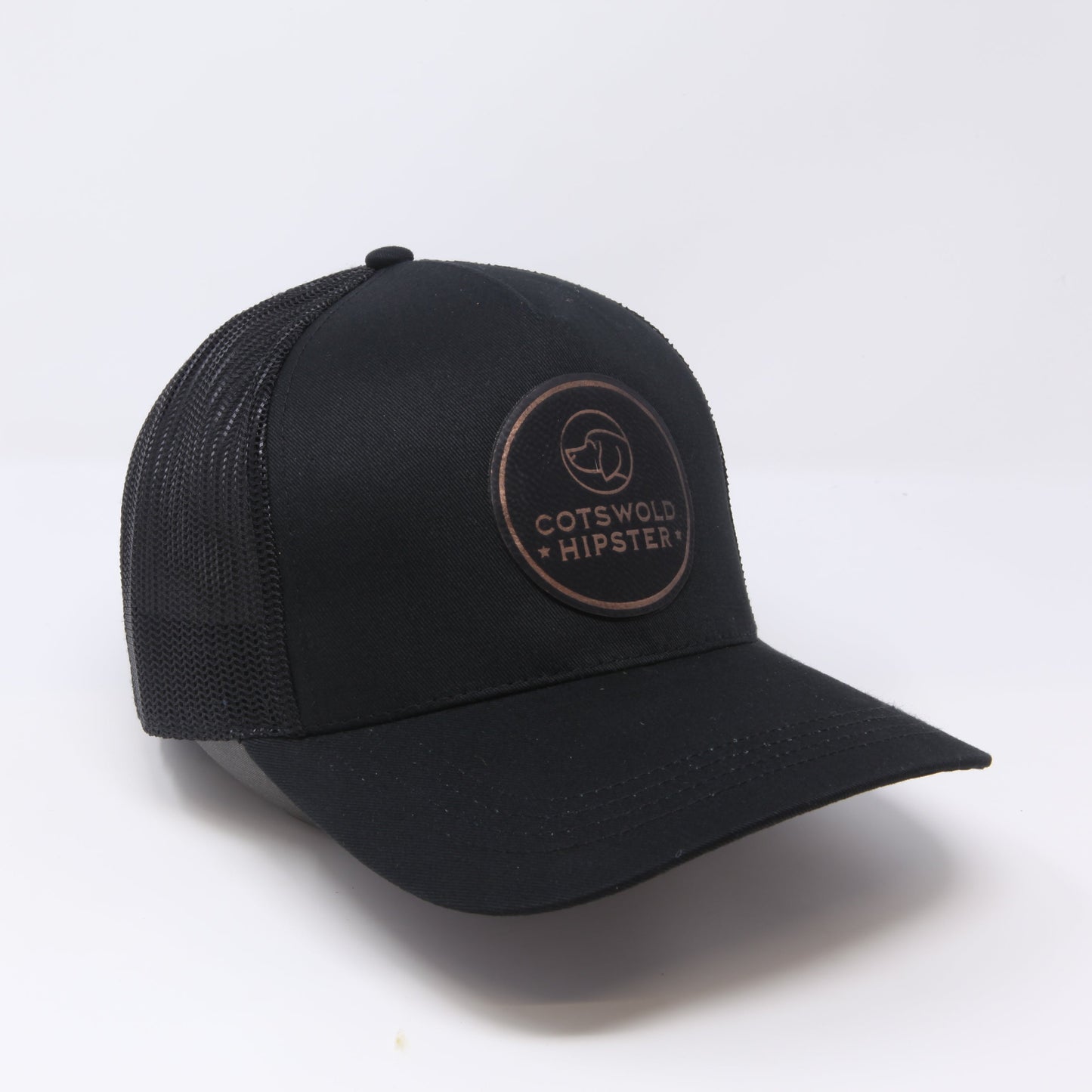 Black Field Cap angled to the side on white background, highlighting logo patch, mesh panels, and snap-back closure.