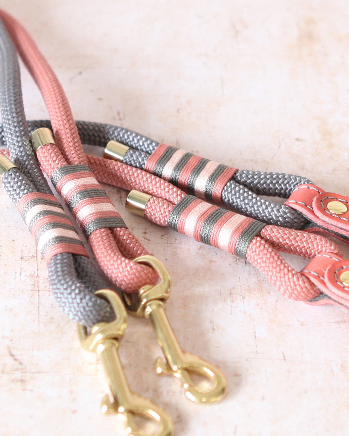 Close-up of the solid brass trigger clip on a Coral & Charcoal Limited Edition leather and rope dog lead.