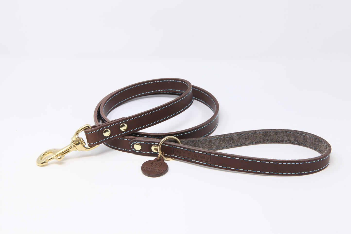 Chocolate leather dog lead by Cotswold Hipster with cornflower blue contrast stitching, brown marl felt lining, and solid brass hardware