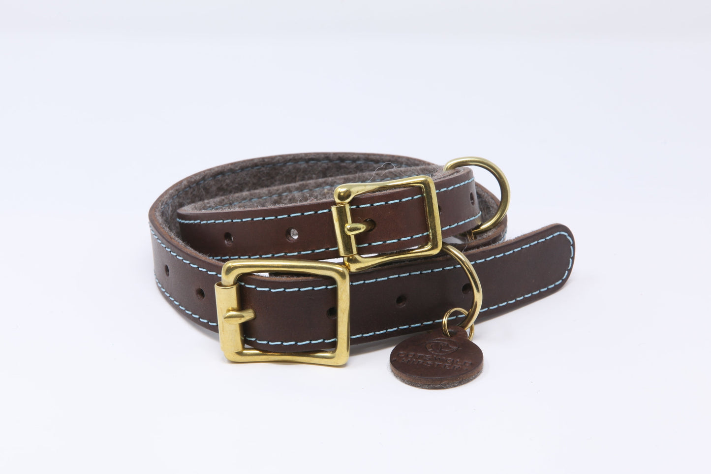 Luxury leather dog collars in chocolate and cornflower, stacked to display fine stitching and premium finish
