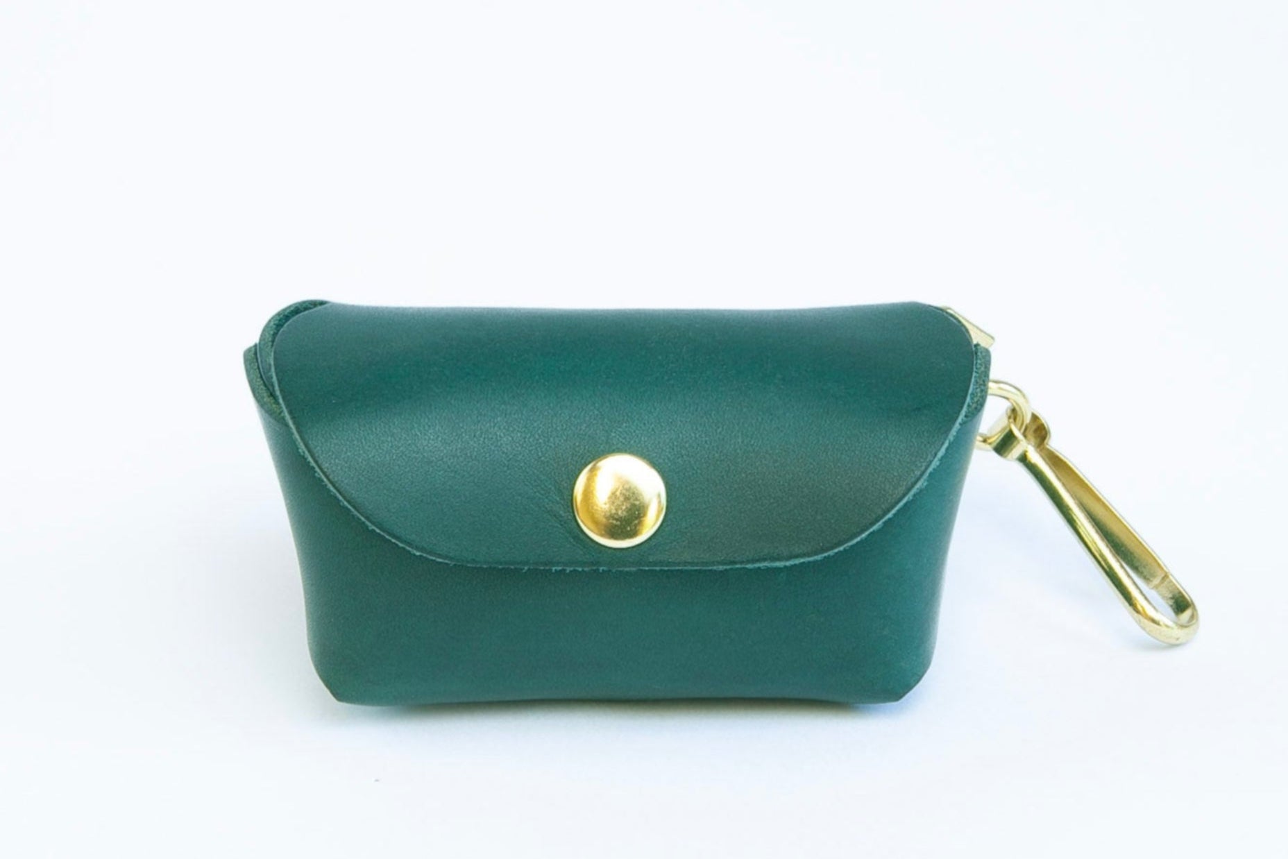 Front view of Teal leather poop bag holder with pop stud closure, bottom dispensing hole, and brass clip for attaching, made by Cotswold Hipster