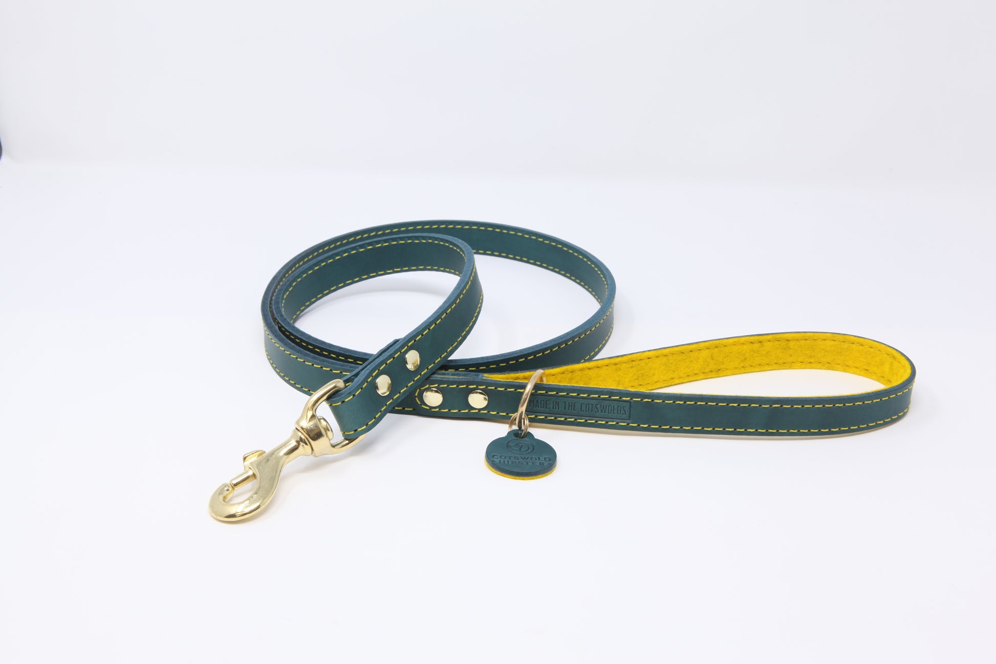Teal leather dog lead by Cotswold Hipster with mustard contrast stitching, mustard felt lining, and solid brass hardware