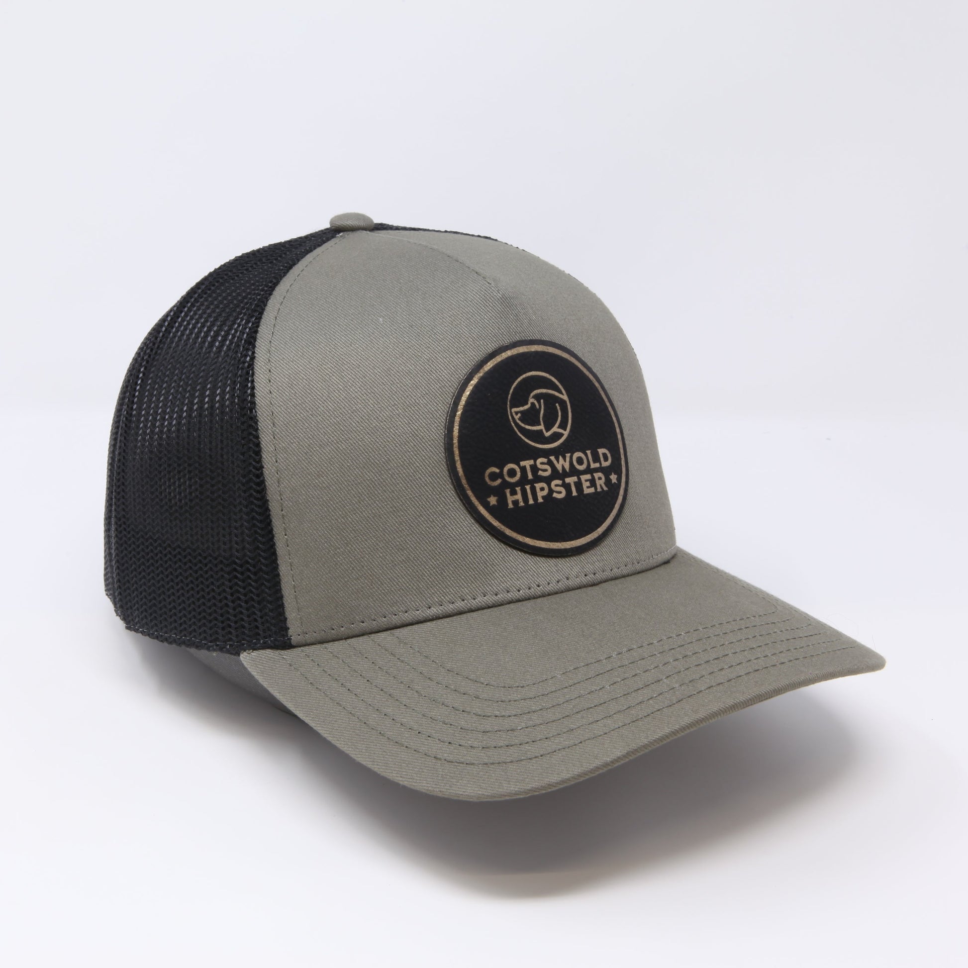 Khaki Field Cap angled to the side on white background, showing logo patch, mesh panels, and adjustable snap-back.