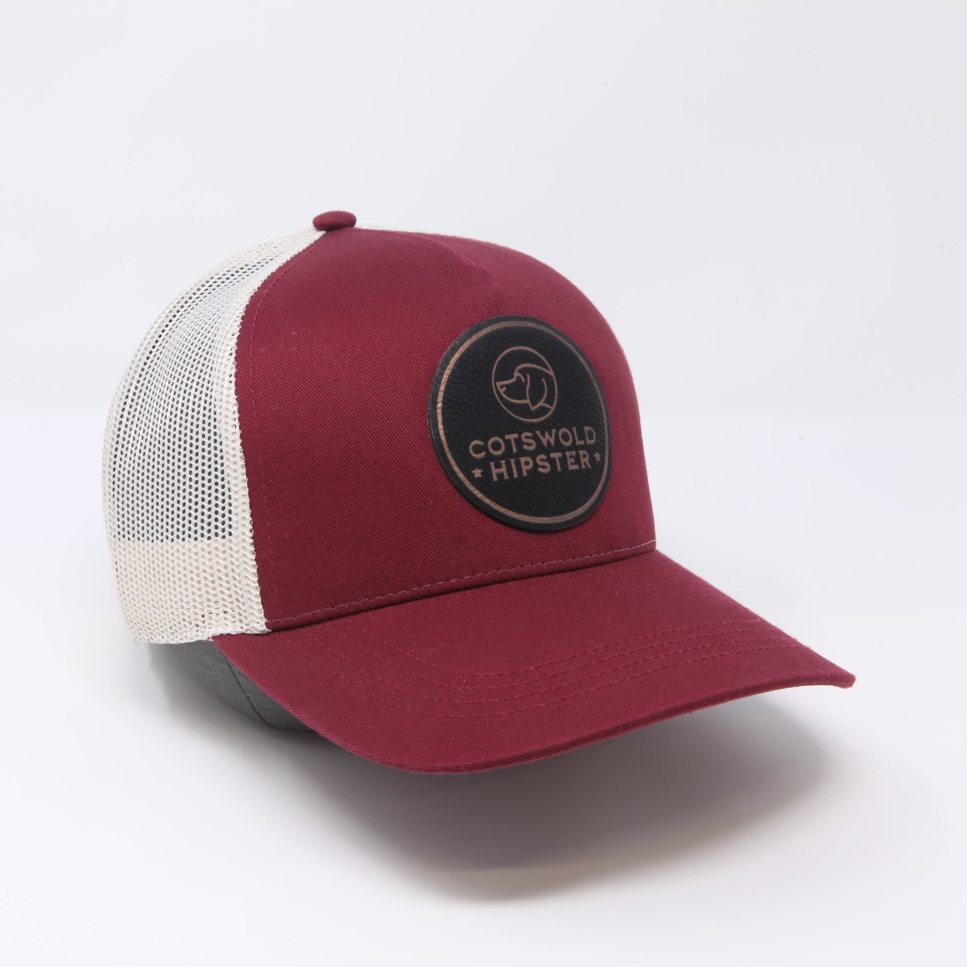 Mulberry Field Cap angled to the side on white background, highlighting logo patch, mesh panels, and snap-back closure.