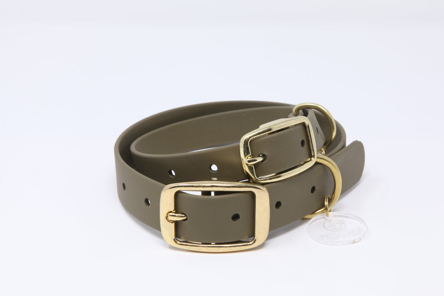 Stack of olive Biothane dog collars with brass hardware in multiple sizes, handmade by Cotswold Hipster 