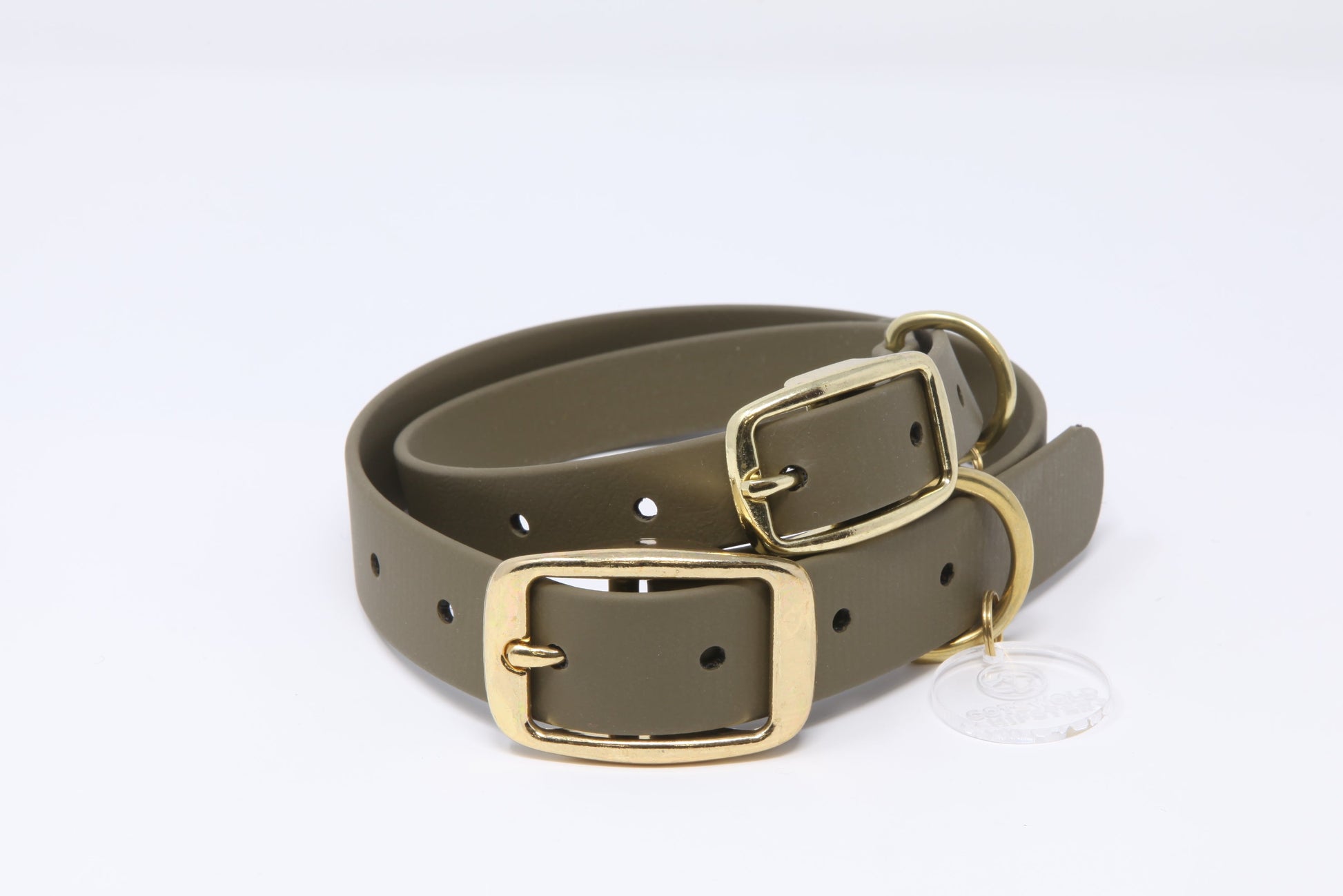 Stack of olive Biothane dog collars with brass hardware in multiple sizes, handmade by Cotswold Hipster 