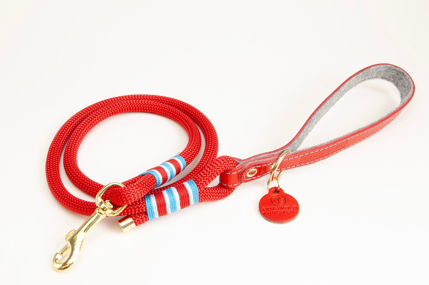 Flat lay of Poppy & Sky leather-handled rope clip lead with plain red rope, showing handle detail, made by Cotswold Hipster