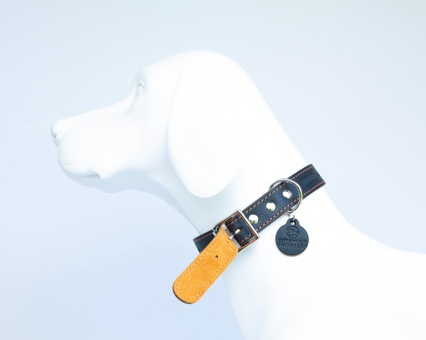 Close-up of tangerine suede lining on handmade navy leather dog collar from the Summer Fair Collection