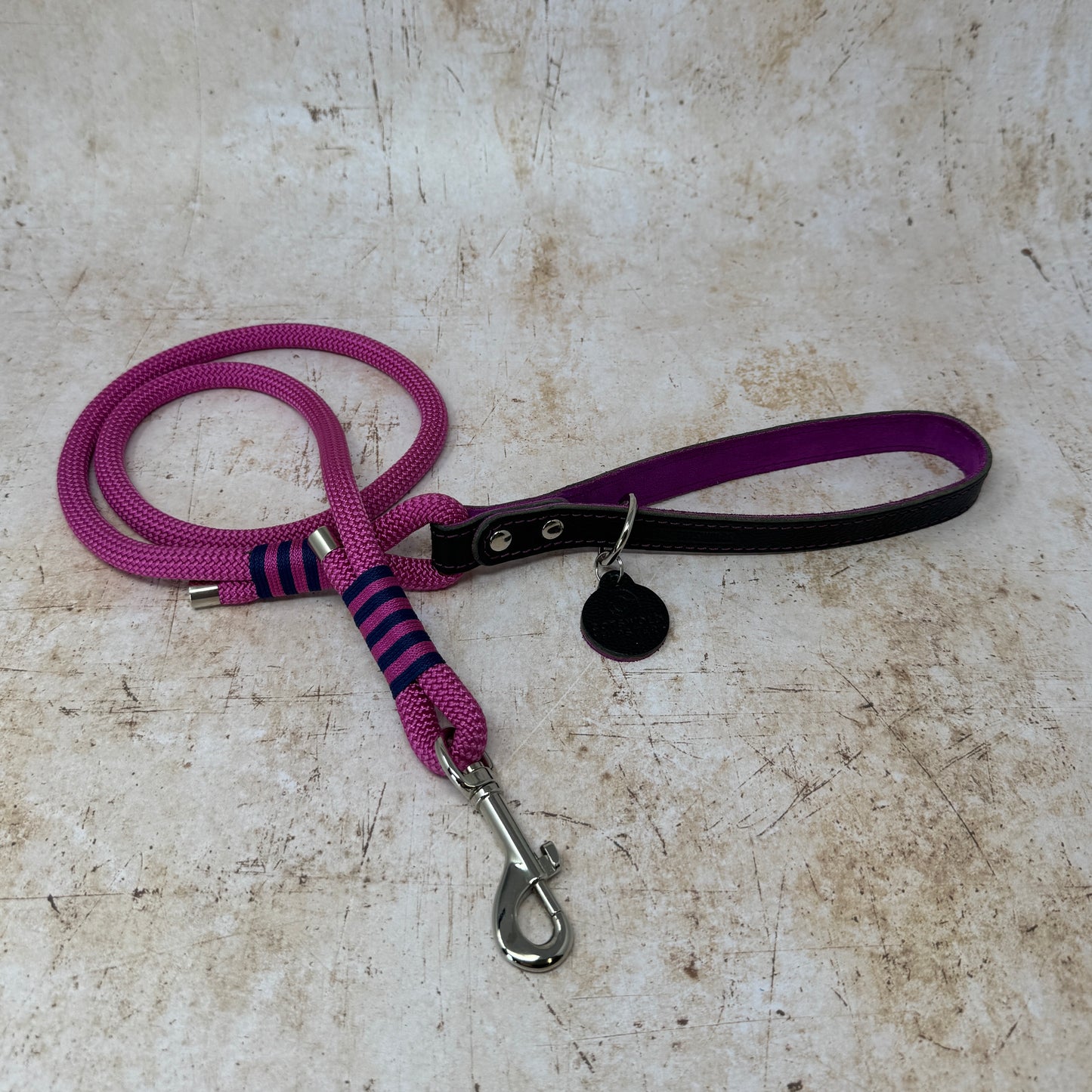 Handmade leather and rope dog lead with fuchsia rope, navy leather handle and fuchsia suede lining from the Summer Fair Collection
