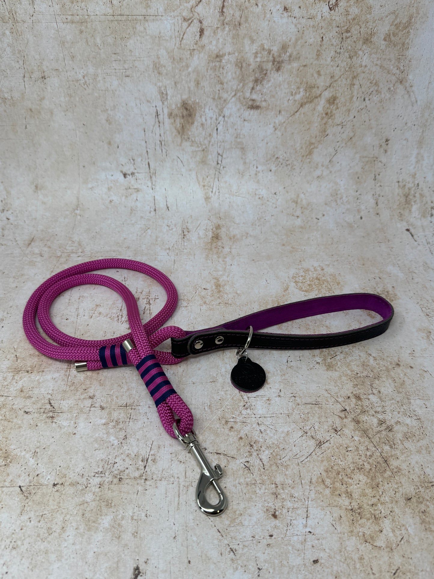 Handmade leather and rope dog lead with fuchsia rope, navy leather handle and fuchsia suede lining from the Summer Fair Collection