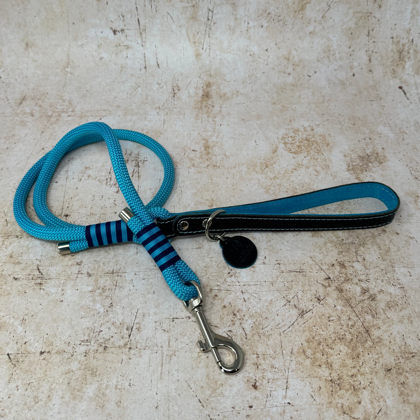 Handmade leather and rope dog lead with turquoise rope, navy leather handle and turquoise suede lining from the Summer Fair Collection