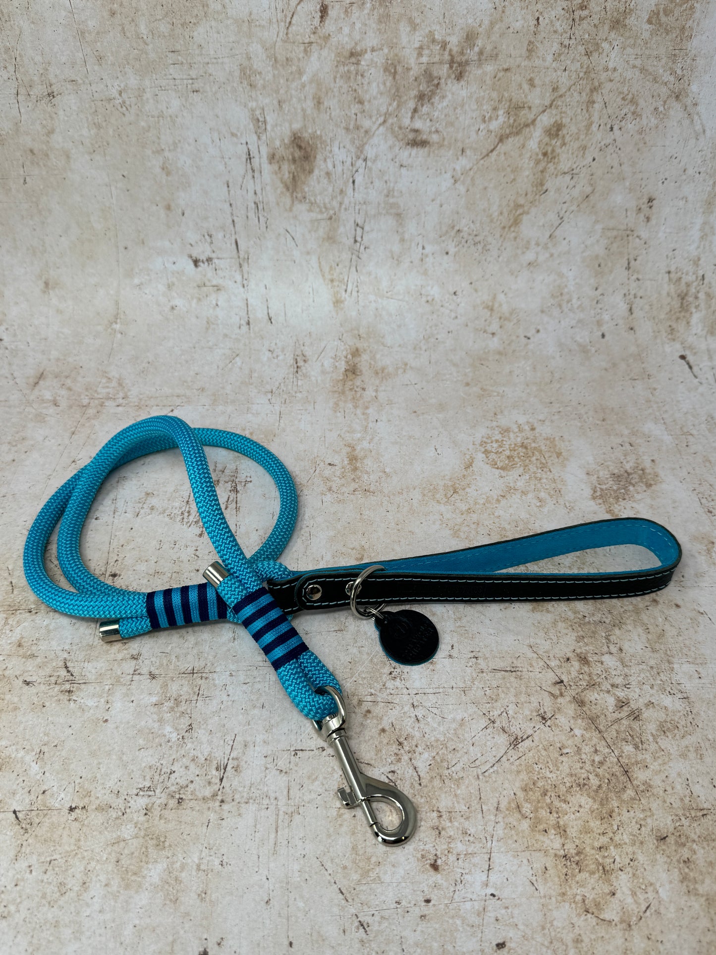 Handmade leather and rope dog lead with turquoise rope, navy leather handle and turquoise suede lining from the Summer Fair Collection