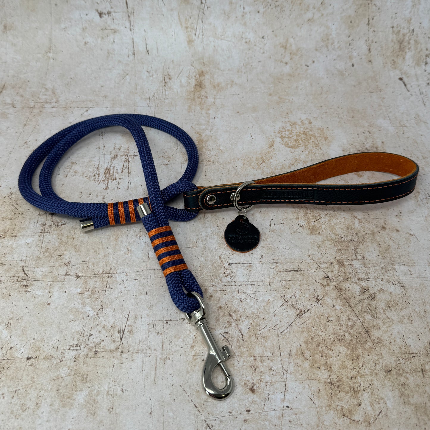 Handmade leather and rope dog lead with navy rope, navy leather handle and tangerine suede lining from the Summer Fair Collection