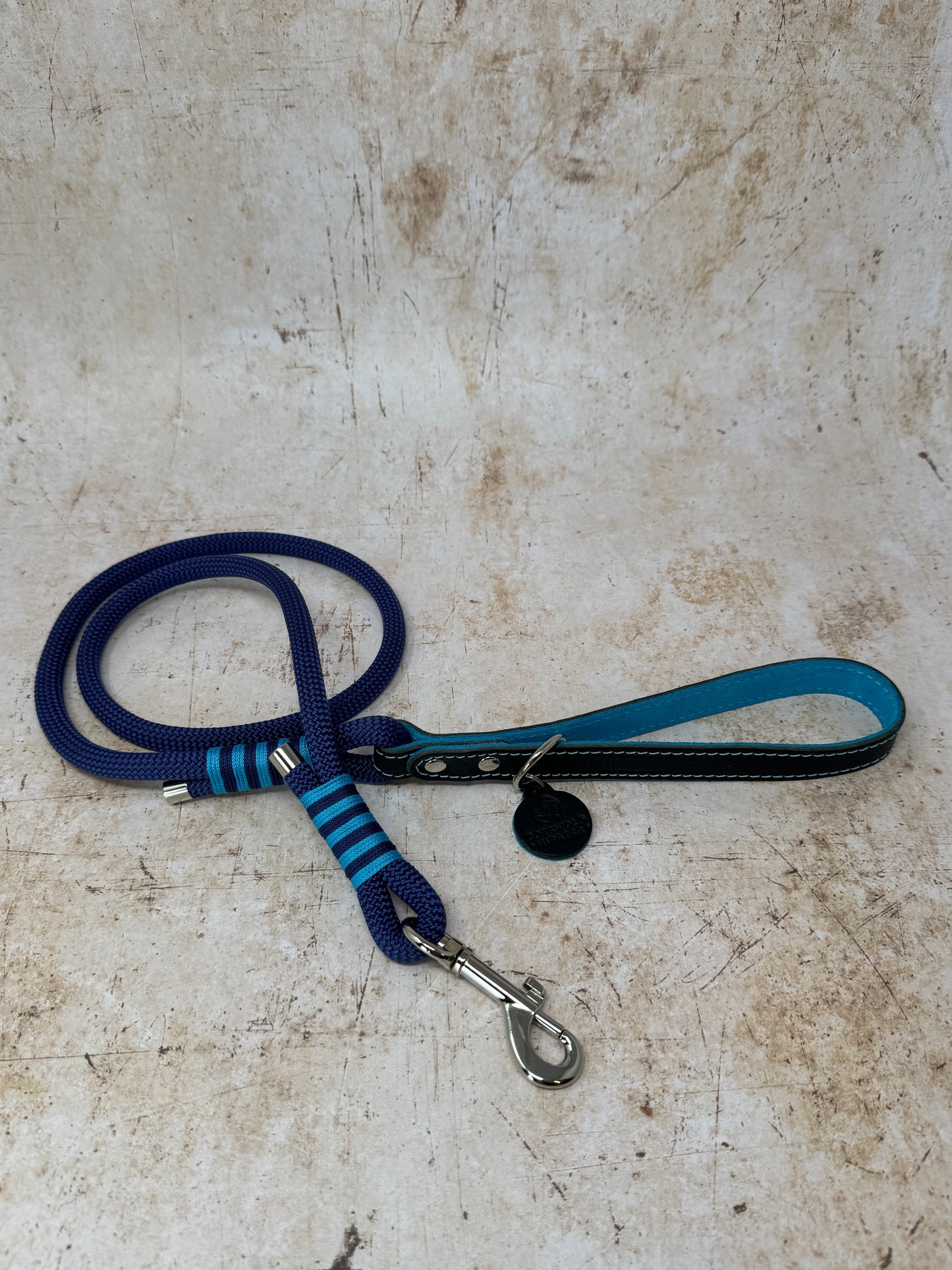 Handmade rope dog lead in French navy with turquoise stripe detailing and leather handle from the Summer Fair Collection