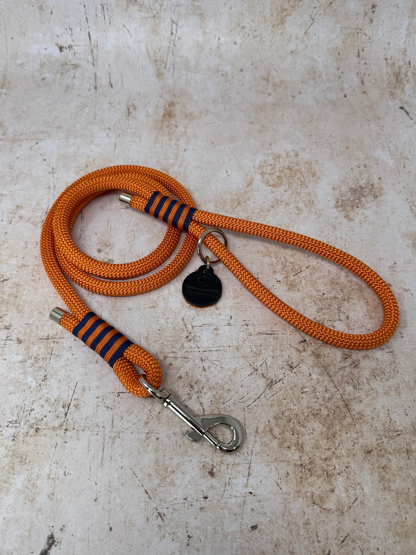 Handmade rope-handle dog lead in French navy with bold tangerine stripe detailing and nickel hardware from the Summer Fair Collection