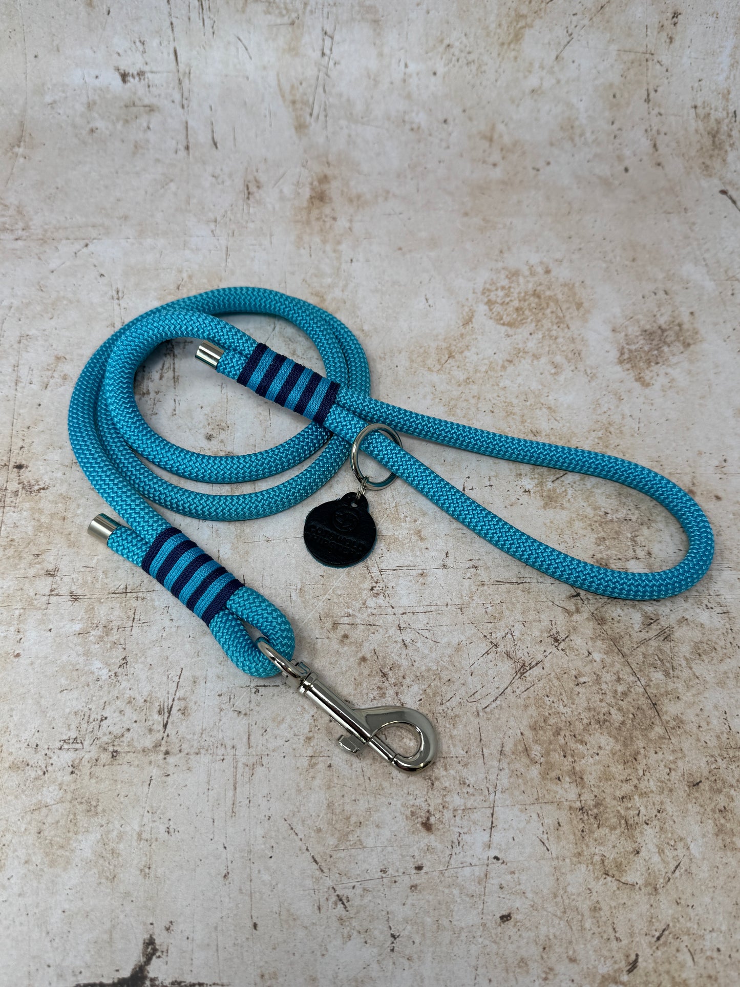 Handmade rope-handle dog lead in French navy with bold turquoise stripe detailing and nickel hardware from the Summer Fair Collection