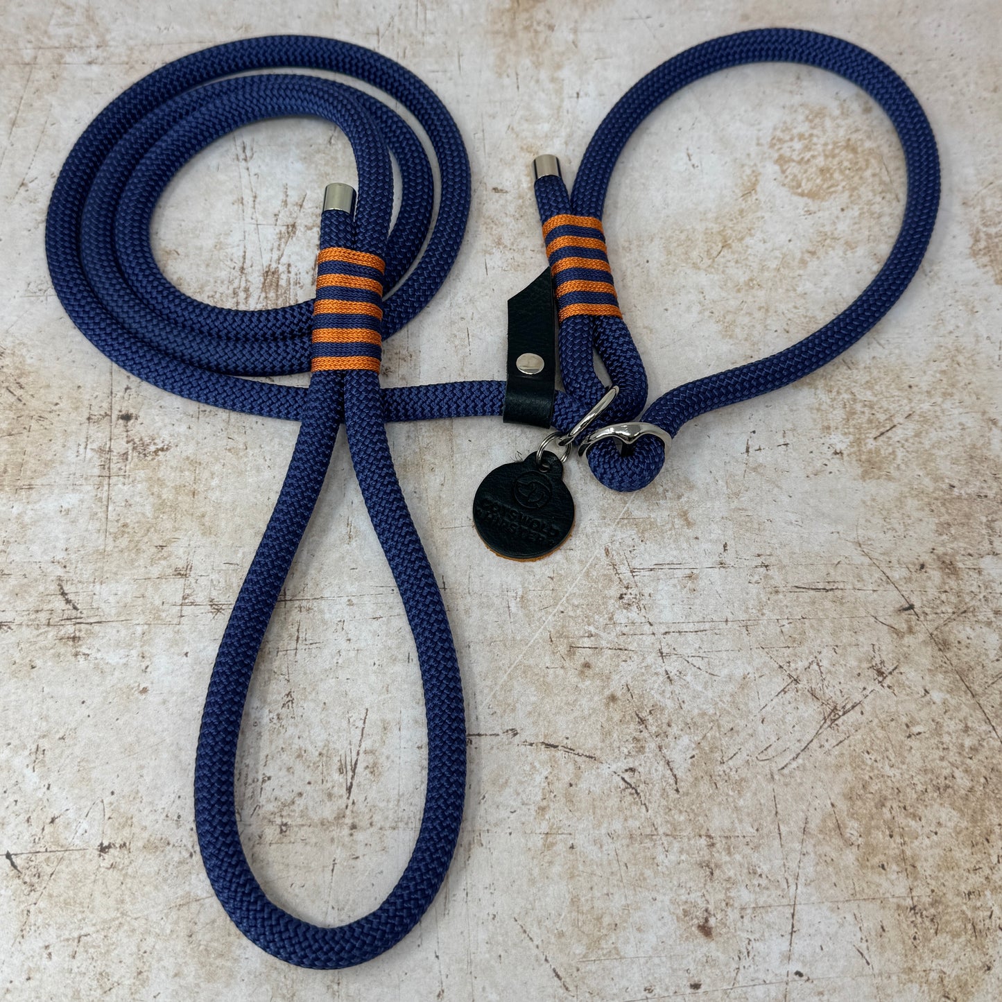 Handmade rope slip lead in French navy with bold tangerine stripe detailing and nickel hardware from the Summer Fair Collection