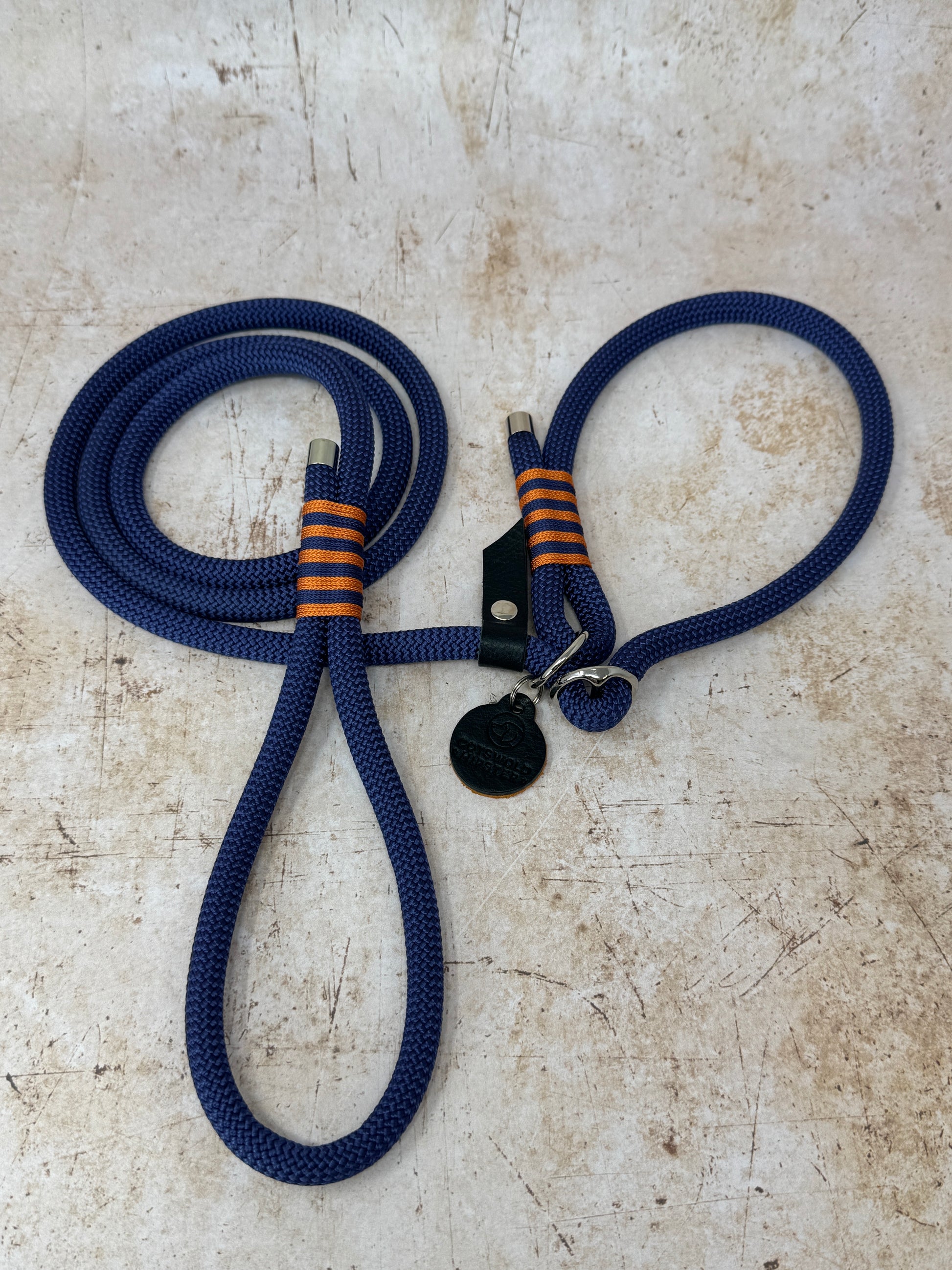 Handmade rope slip lead in French navy with bold tangerine stripe detailing and nickel hardware from the Summer Fair Collection